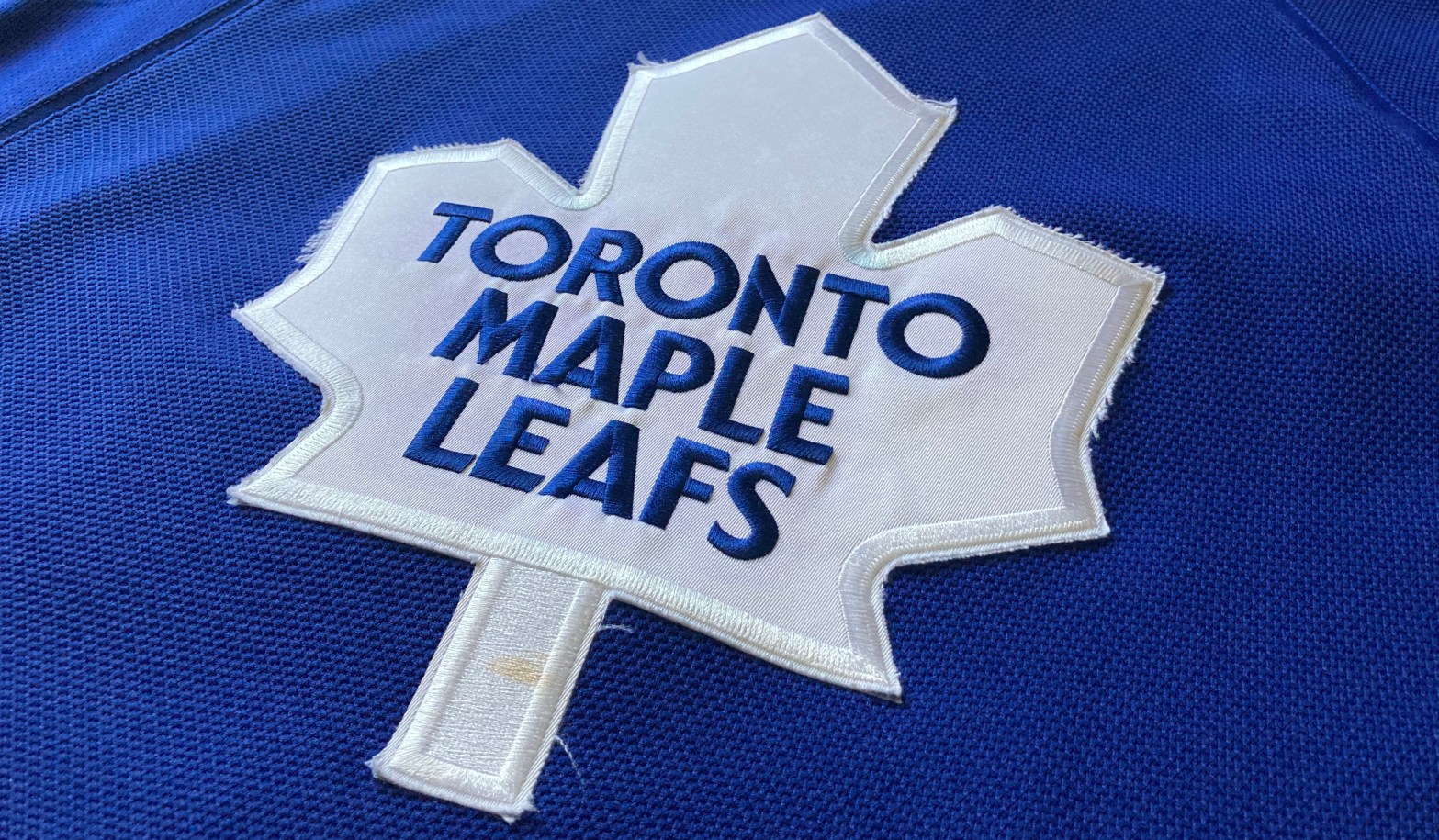 The logo of the Toronto Maple Leafs on the front of a jersey