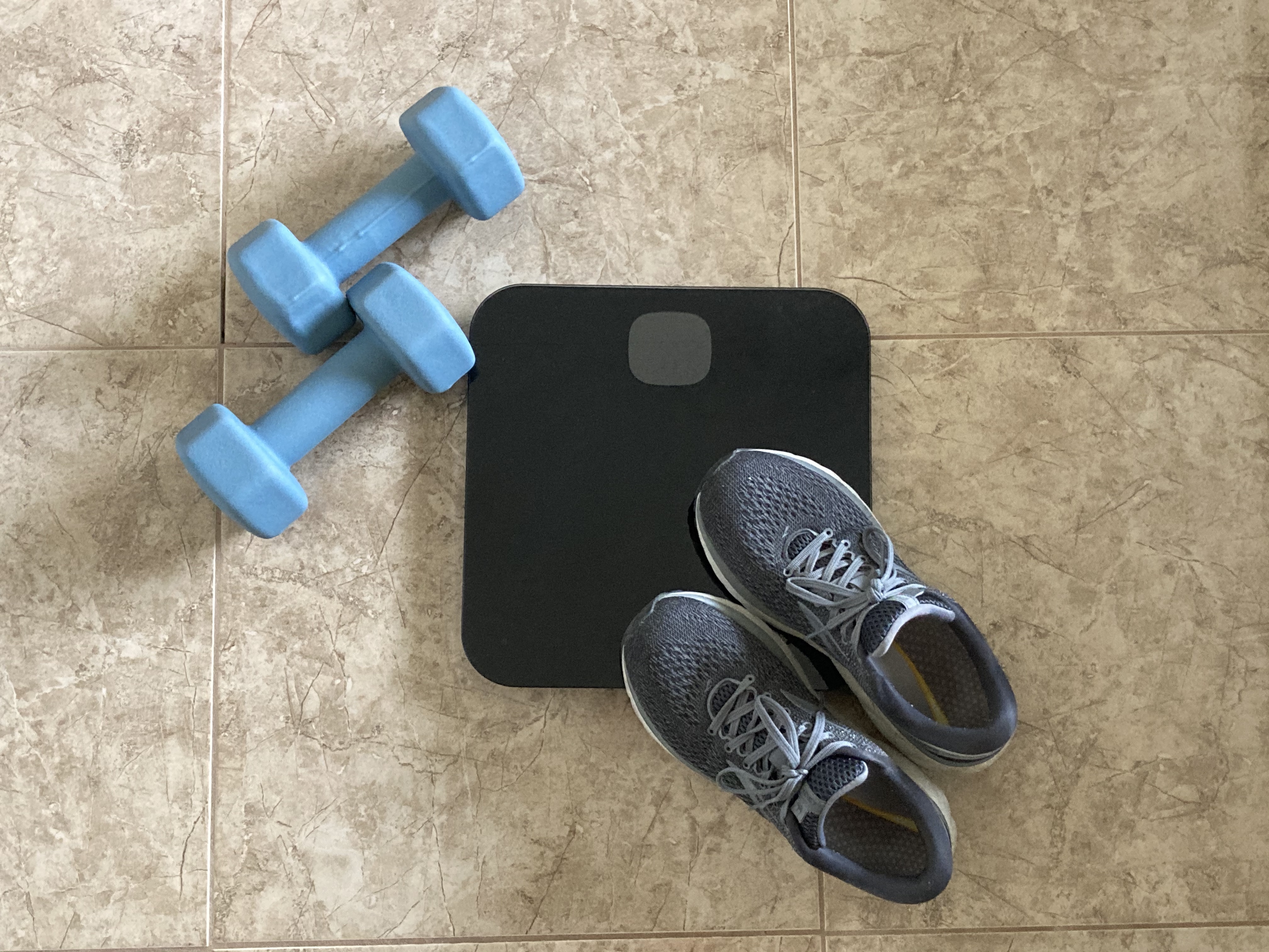 Getting back on track with my fitness goals, showing my scale and dumbbells.